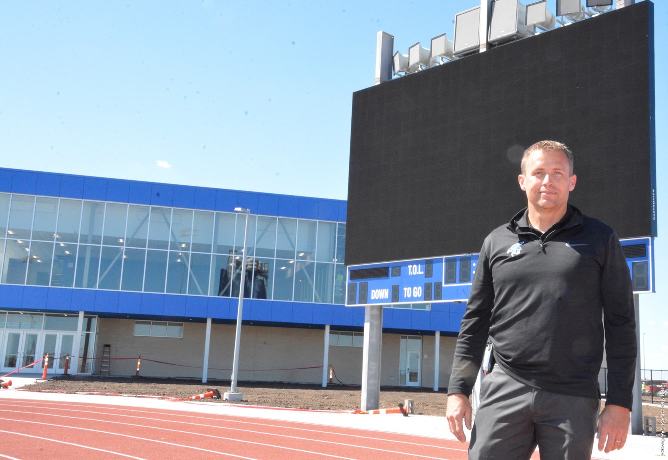 JCHS athletic director Matt Westerhaus in front of the video board.